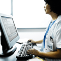 QA Portal - Image of a physician working on a computer
